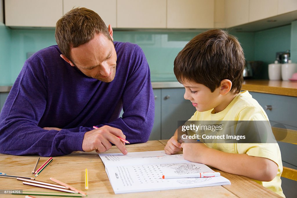 Father helping his son with his homework