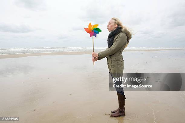 young woman by sea with pinwheel - 紙風車 ストックフォトと画像