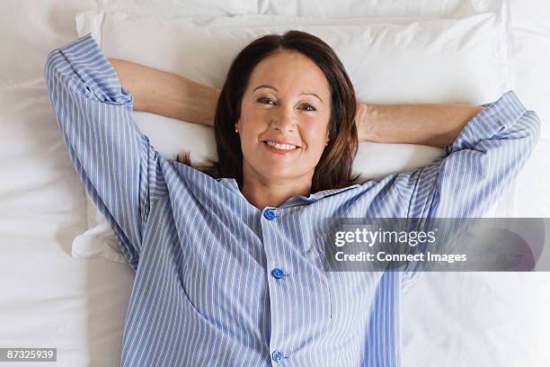 portrait of a mature woman having breakfast - pajamas stock pictures, royalty-free photos & images