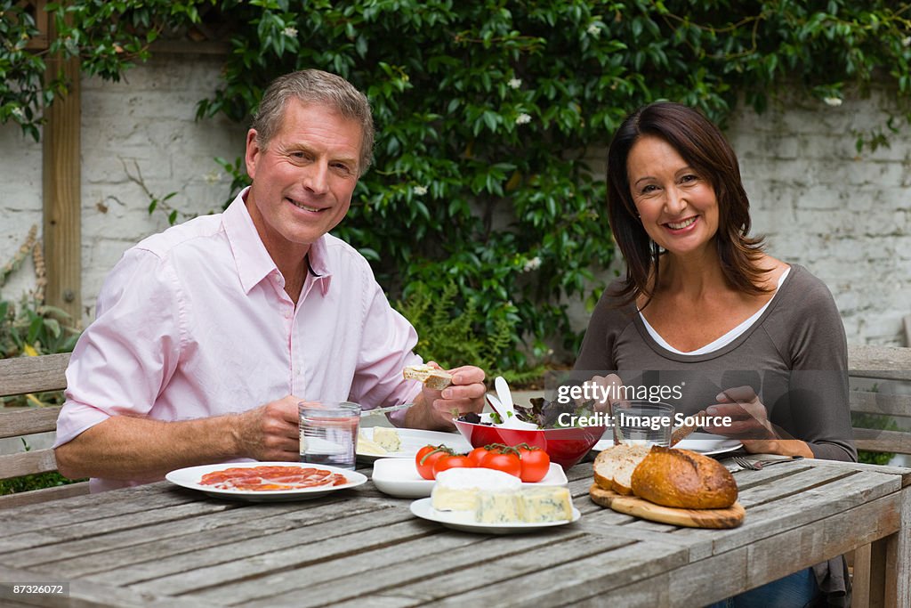 Mature woman and senior man dining al fresco