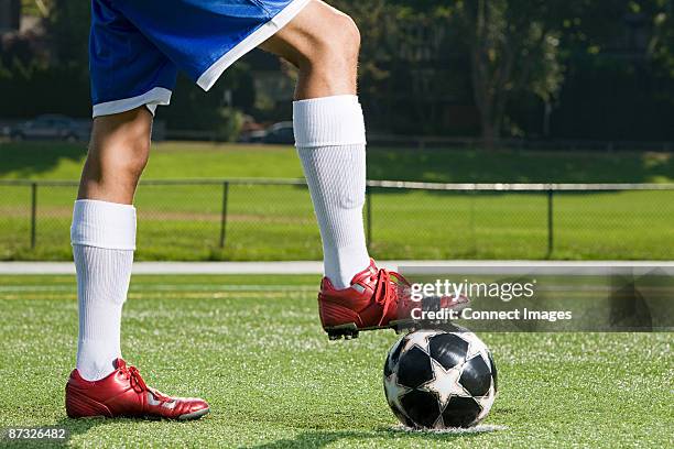 legs of a footballer and football - soccer boot stock pictures, royalty-free photos & images