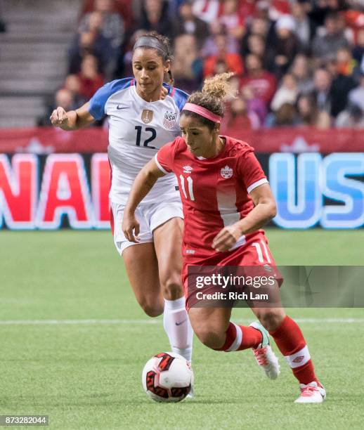 Desiree Scott of Canada tries to break free from Lynn Williams of the United States during International Friendly soccer match action at BC Place on...