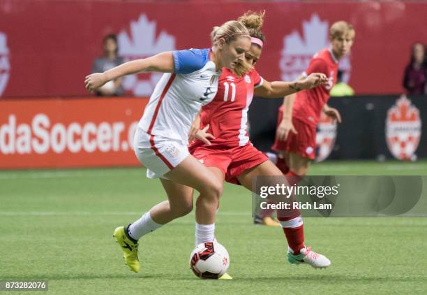 Lindsey Horan of the United States tries to fight off the check of Desiree Scott of Canada during International Friendly soccer match action at BC...