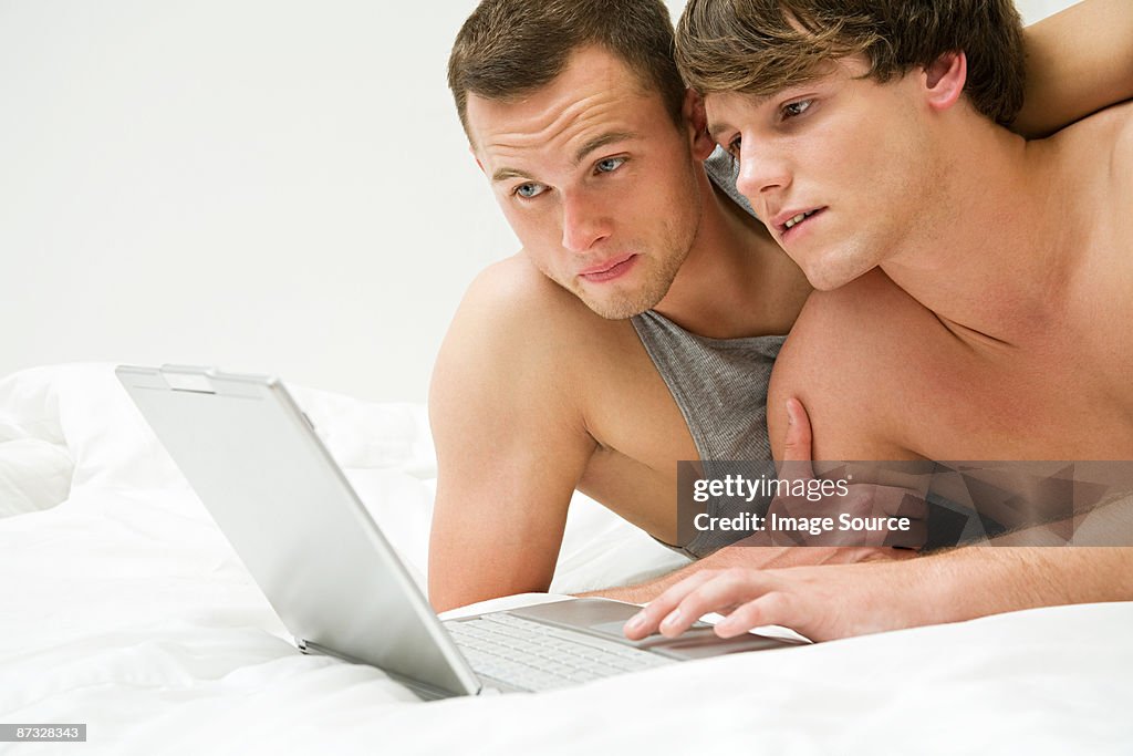 A gay couple using a laptop