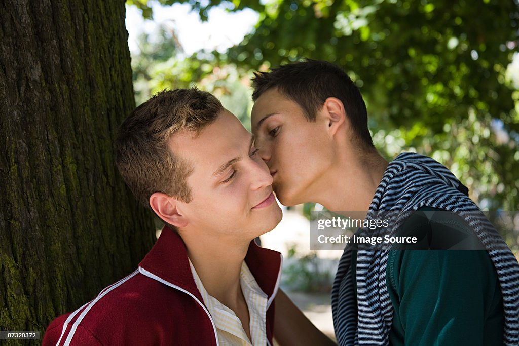 A man kissing his partner on the cheek