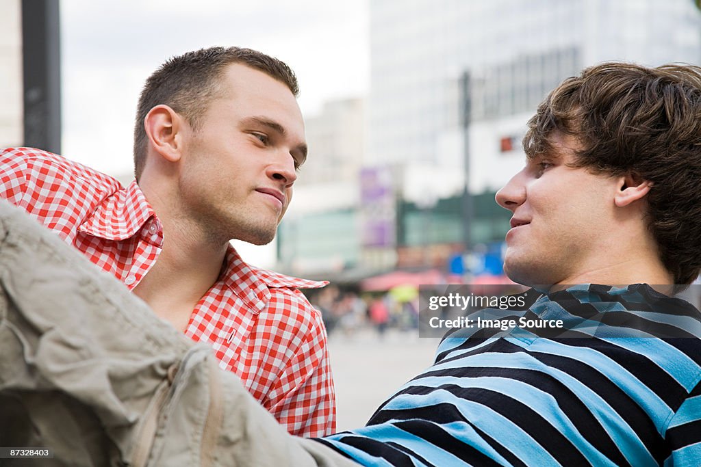 A gay couple looking at each other