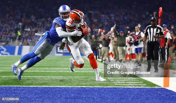 Kenny Britt of the Cleveland Browns scores a touchdown against Glover Quin of the Detroit Lions during the first quarter at Ford Field on November...