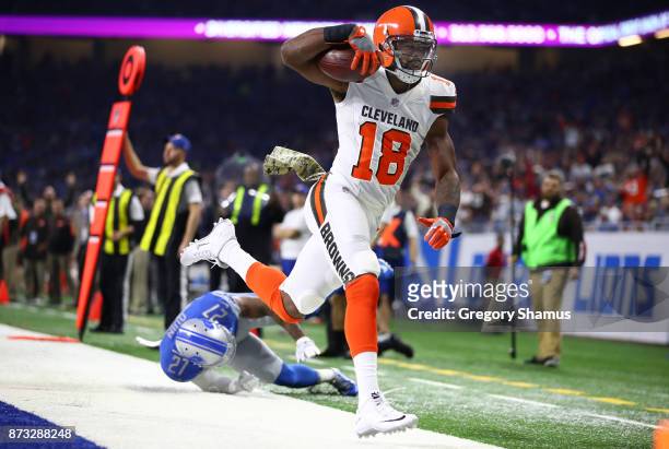 Kenny Britt of the Cleveland Browns scores a touchdown against Glover Quin of the Detroit Lions during the first quarter at Ford Field on November...