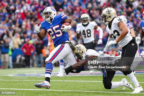 LeSean McCoy of the Buffalo Bills runs the ball as Rafael Bush of the New Orleans Saints and Marshon Lattimore of the New Orleans Saints attempt to...
