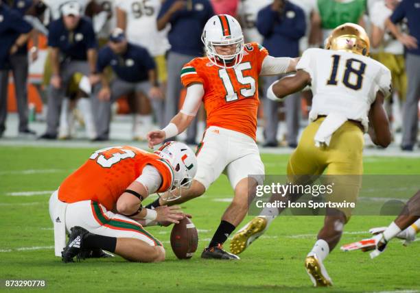 University of Miami Hurricanes Kicker Michael Badgley kicks an extra point under pressure from Notre Dame Cornerback Troy Pride Jr. During the...