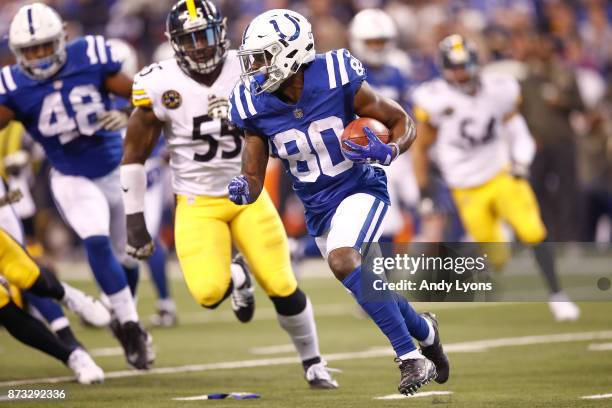 Chester Rogers of the Indianapolis Colts returns a punt, chased by Arthur Moats of the Pittsburgh Steelers, during the first quarter at Lucas Oil...