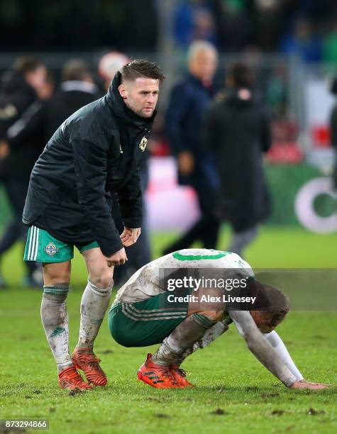 George Saville of Northern Ireland is consoled by Oliver Norwood of Northern Ireland following the FIFA 2018 World Cup Qualifier Play-Off: Second Leg...