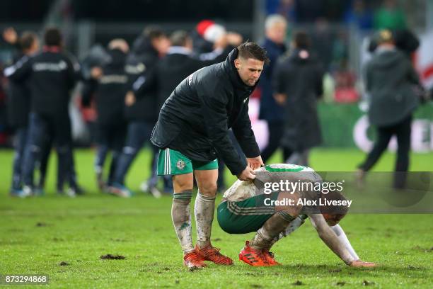 George Saville of Northern Ireland is consoled by Oliver Norwood of Northern Ireland following the FIFA 2018 World Cup Qualifier Play-Off: Second Leg...