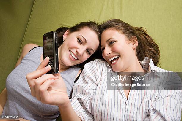 teenage girls photographing themselves on a cell phone - girls playing with themselves bildbanksfoton och bilder