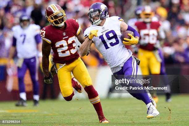 Wide receiver Adam Thielen of the Minnesota Vikings runs upfield against DeAngelo Hall of the Washington Redskins after a reception during the second...