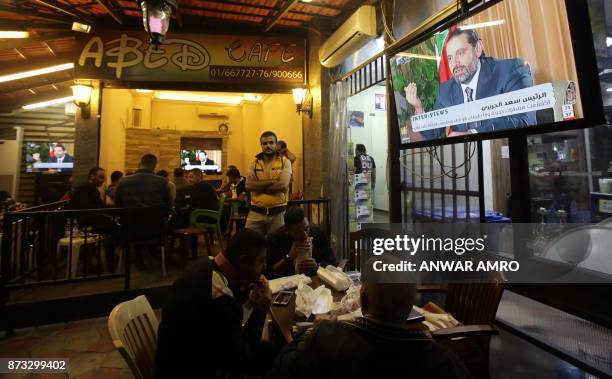 Lebanese watch an interview with Lebanon's resigned prime minister Saad Hariri at a coffee shop in Beirut on November 12, 2017. Saad Hariri pledged...