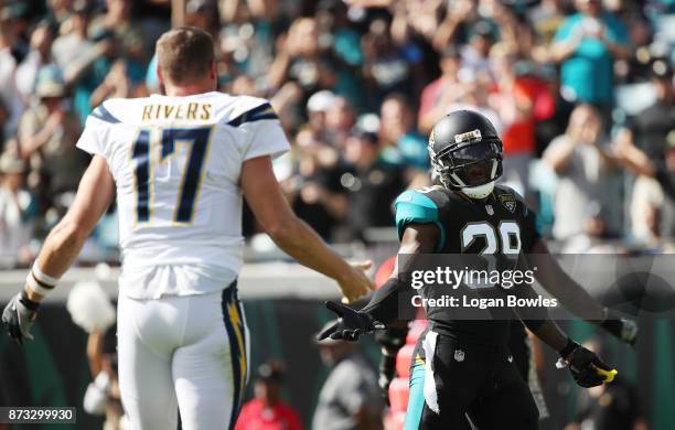 Tashaun Gipson of the Jacksonville Jaguars looks at Philip Rivers of the Los Angeles Chargers on the field during the first half of their game at...