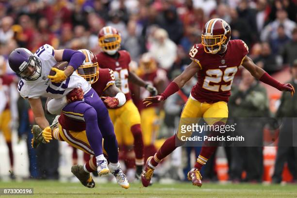 Wide receiver Adam Thielen is tackled by inside linebacker Zach Brown of the Washington Redskins during the second quarter of the Minnesota Vikings...
