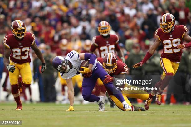 Wide receiver Adam Thielen is tackled by inside linebacker Zach Brown of the Washington Redskins during the second quarter of the Minnesota Vikings...