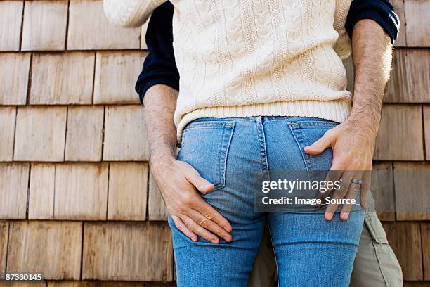hands on buttocks - womens bottoms stockfoto's en -beelden