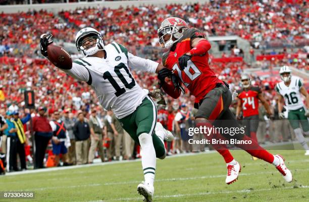 Wide receiver Jermaine Kearse of the New York Jets fails to haul in a pass in the end zone by quarterback Josh McCown while getting pressure from...