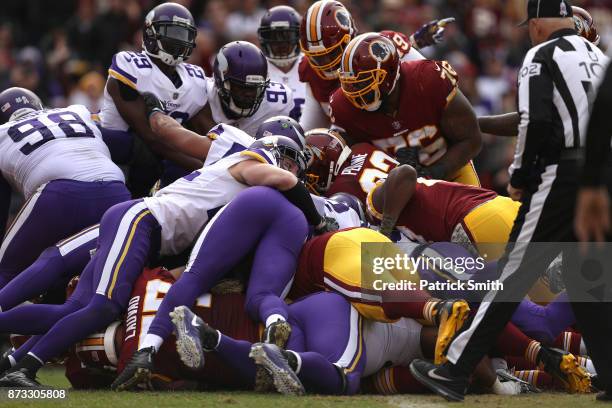 Quarterback Kirk Cousins of the Washington Redskins scores a touchdown during the second quarter against the Minnesota Vikings at FedExField on...