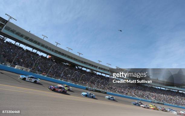 Ryan Blaney, driver of the SKF/Quick Lane Tire & Auto Center Ford, and Denny Hamlin, driver of the FedEx Ground Toyota, lead the field at the start...