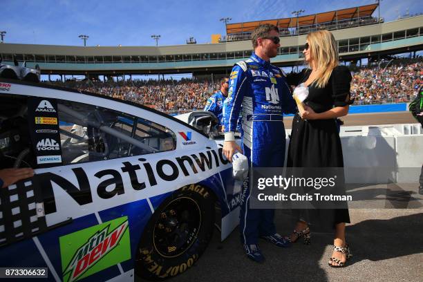 Dale Earnhardt Jr., driver of the Nationwide Chevrolet, talks with Amy Earnhardt as he prepares to drive during the Monster Energy NASCAR Cup Series...