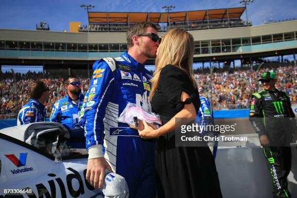 Dale Earnhardt Jr., driver of the Nationwide Chevrolet, talks with Amy Earnhardt as he prepares to drive during the Monster Energy NASCAR Cup Series...