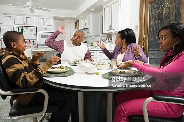 family argument at the dinner table - african at dining table stockfoto's en -beelden