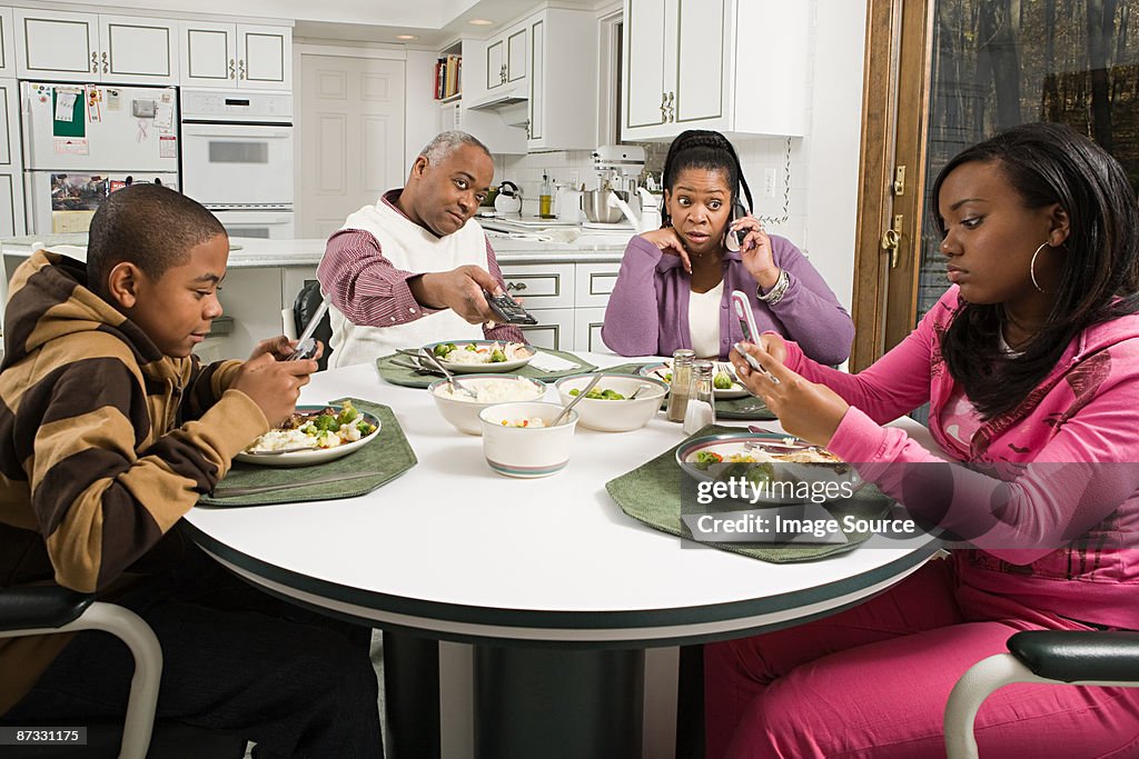 Distracted family at the dinner table