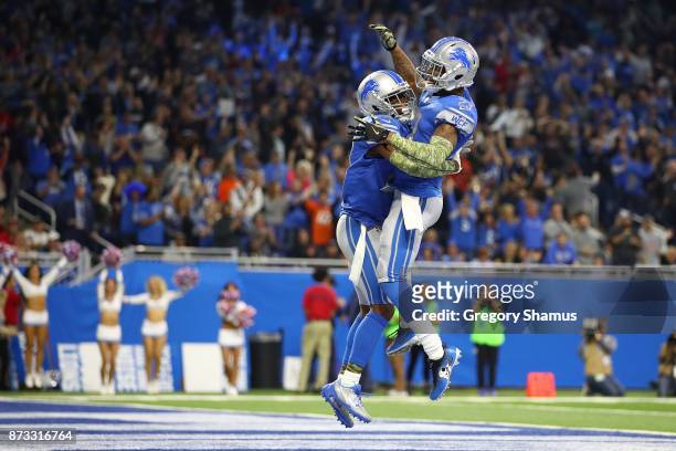 Nevin Lawson of the Detroit Lions celebrates his touchdown run with a teammate after recovering a fumble against the Cleveland Browns during the...