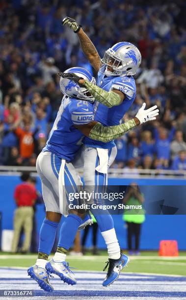 Nevin Lawson of the Detroit Lions celebrates his touchdown run with a teammate after recovering a fumble against the Cleveland Browns during the...