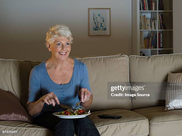 a senior woman having a tv dinner - tv dinner stock pictures, royalty-free photos & images