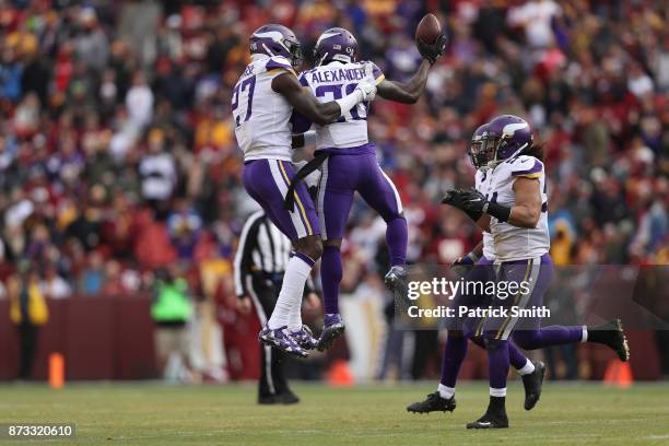 Cornerback Mackensie Alexander of the Minnesota Vikings celebrates with teammates after an interception during the second quarter against the...