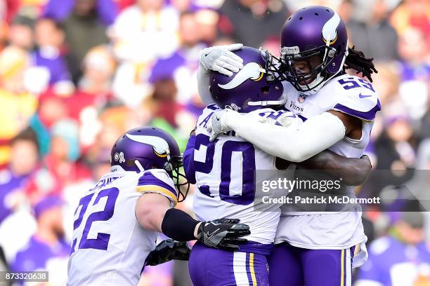 Cornerback Mackensie Alexander of the Minnesota Vikings celebrates with Harrison Smith and Emmanuel Lamur after an interception during the second...