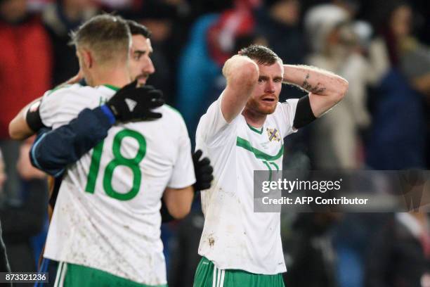 Northern Ireland's midfielder Chris Brunt reacts at the end of the FIFA 2018 World Cup play-off second leg qualifying football match between...