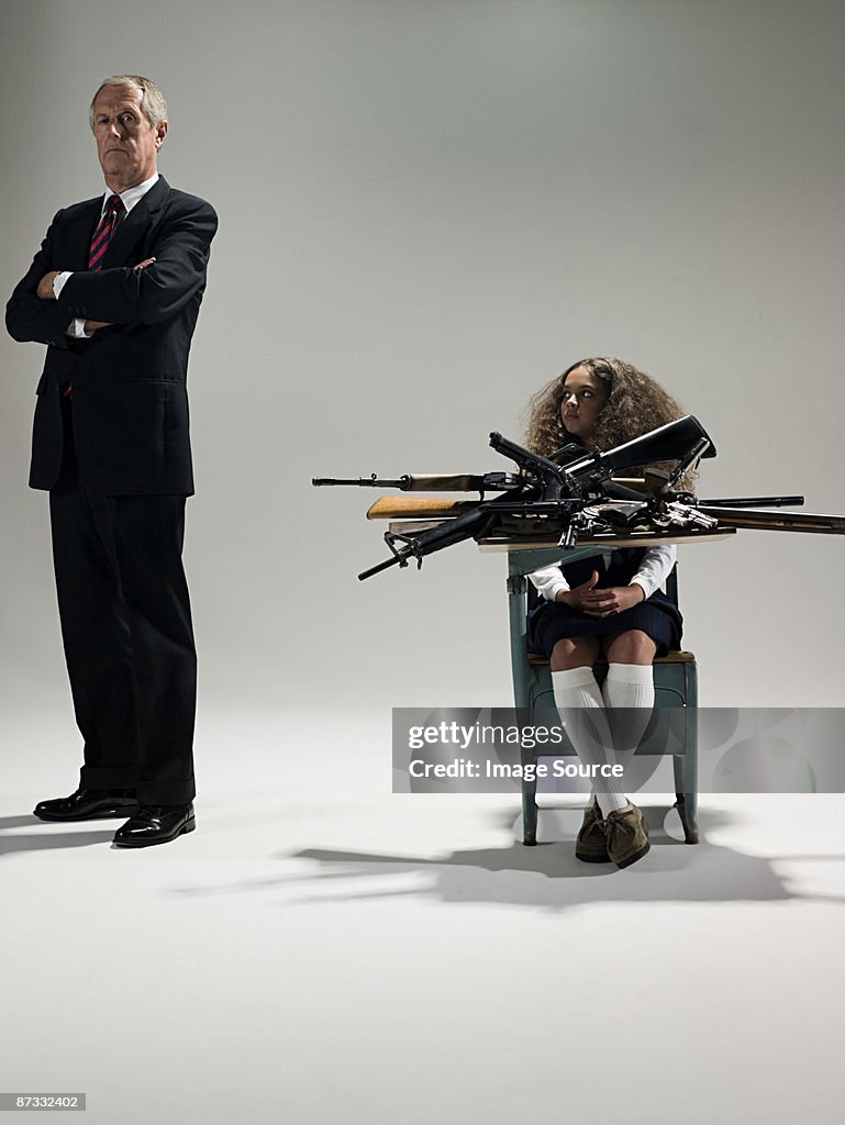 Man and schoolgirl with guns