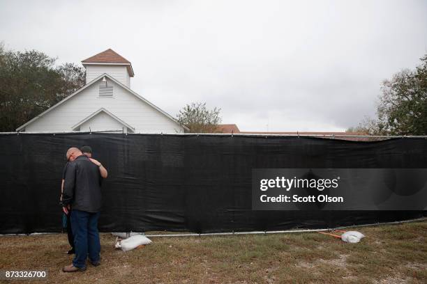 Pople embrace in front of the First Baptist Church of Sutherland Springs on November 12, 2017 in Sutherland Springs, Texas. The congregation held...