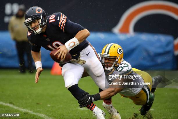 Quarterback Mitchell Trubisky of the Chicago Bears is sacked by Nick Perry of the Green Bay Packers in the third quarter at Soldier Field on November...