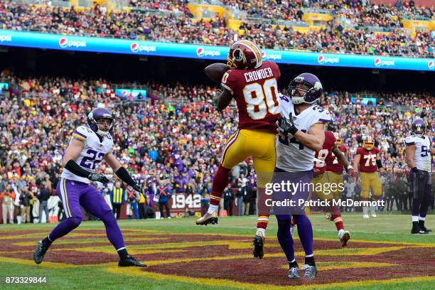 Wide receiver Jamison Crowder of the Washington Redskins attempts to pull in a catch during the third quarter against the Minnesota Vikings at...