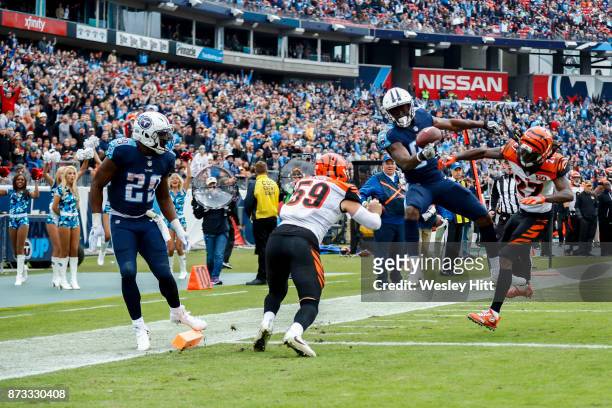 Wide Receiver Corey Davis of the Tennessee Titans tries to control the ball against Cornerback Dre Kirkpatrick of the Cincinnati Bengals at Nissan...
