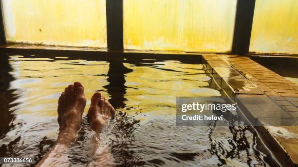 wenjoying hot spring water on hokkaido - hot spring stock pictures, royalty-free photos & images