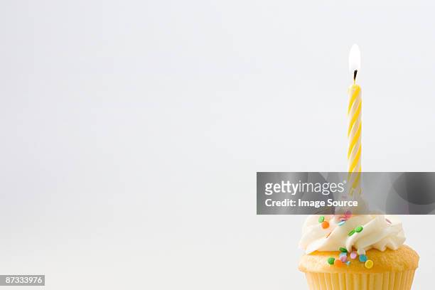 birthday candle on a cup cake - birthday cake stock pictures, royalty-free photos & images
