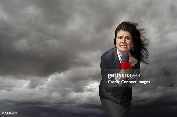 news presenter in storm - weather forecaster stock pictures, royalty-free photos & images