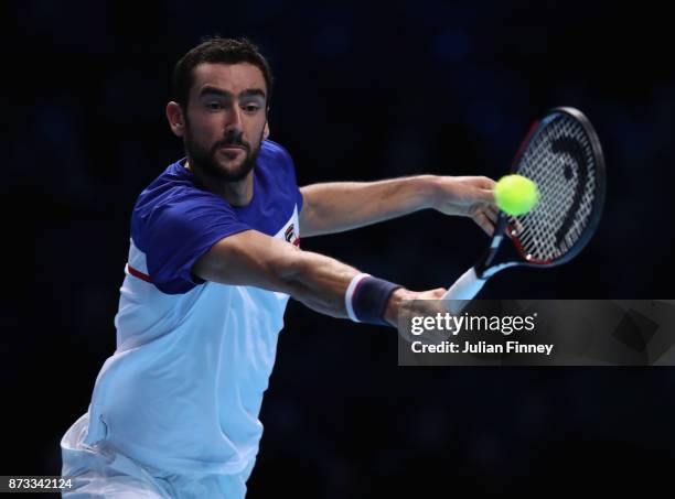 Marin Cilic of Croatia plays a backhand in his match against Alexander Zverev of Germany during day one of the Nitto ATP World Tour Finals tennis at...