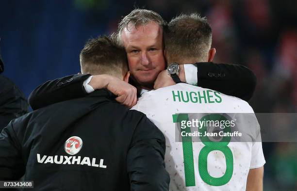 Coach of Northern Ireland Michael O'Neill consoles Oliver Norwood and Aaron Hughes following the FIFA 2018 World Cup Qualifier Play-Off: Second Leg...