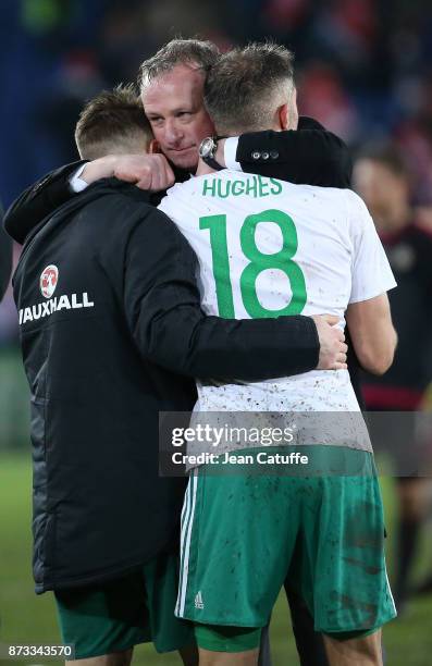 Coach of Northern Ireland Michael O'Neill consoles Oliver Norwood and Aaron Hughes following the FIFA 2018 World Cup Qualifier Play-Off: Second Leg...