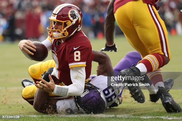 Quarterback Kirk Cousins of the Washington Redskins runs for a touchdown during the fourth quarter against the Minnesota Vikings at FedExField on...