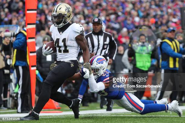 Alvin Kamara of the New Orleans Saints runs the ball as Micah Hyde of the Buffalo Bills attempts to tackle him during the third quarter on November...